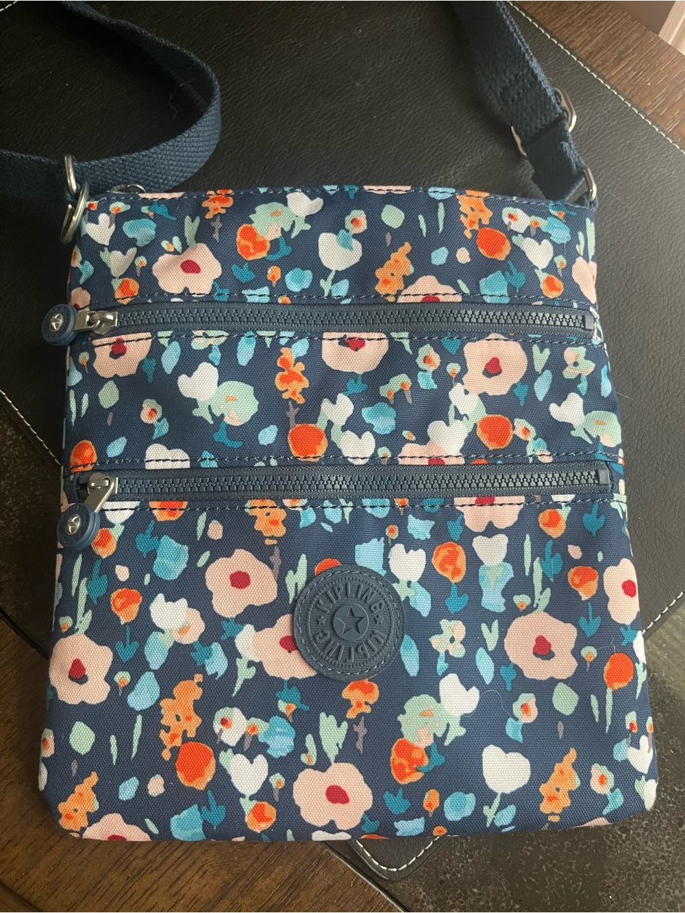 NWOT Kipling Navy Floral Crossbody with Orange & Teal Accents.
